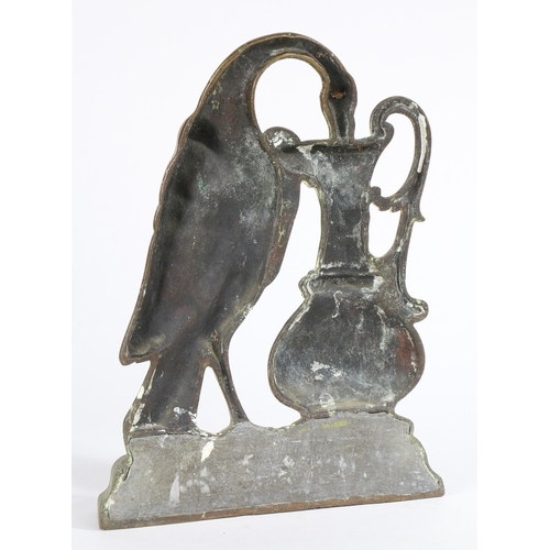 116 - A VICTORIAN CAST BRASS DOOR PORTER. Designed as a bird (pelican?) drinking from a ewer, lead weighte... 