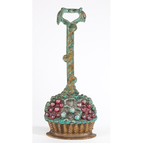 117 - A CAST IRON AND PAINTED DOOR PORTER. In the form of a fruit and floral filled basket, 35cm high.