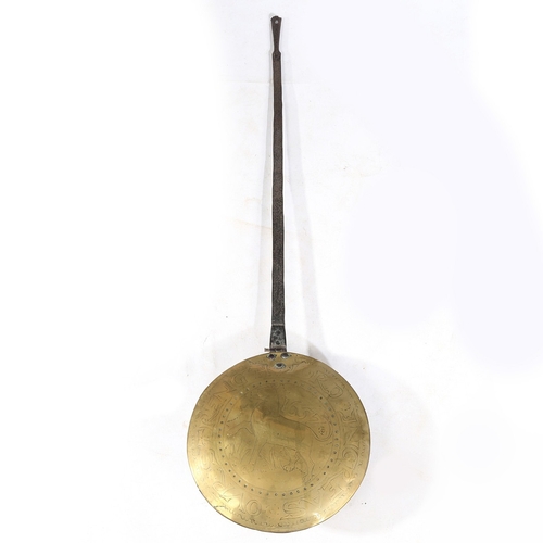 122 - A COMMONWEALTH IRON AND BRASS WARMING PAN, DATED 1657. The circular brass cover decorated with the l... 