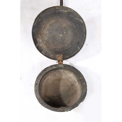 122 - A COMMONWEALTH IRON AND BRASS WARMING PAN, DATED 1657. The circular brass cover decorated with the l... 