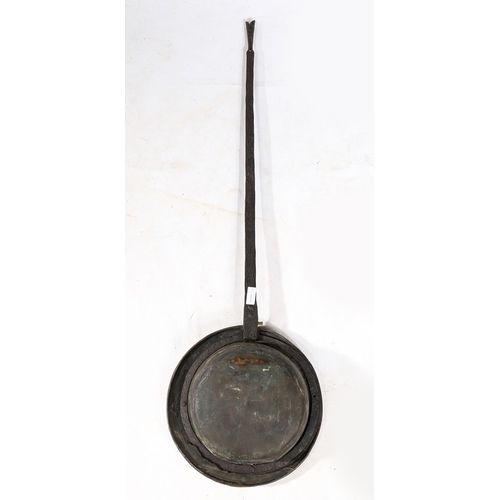 122 - A COMMONWEALTH IRON AND BRASS WARMING PAN, DATED 1657. The circular brass cover decorated with the l... 