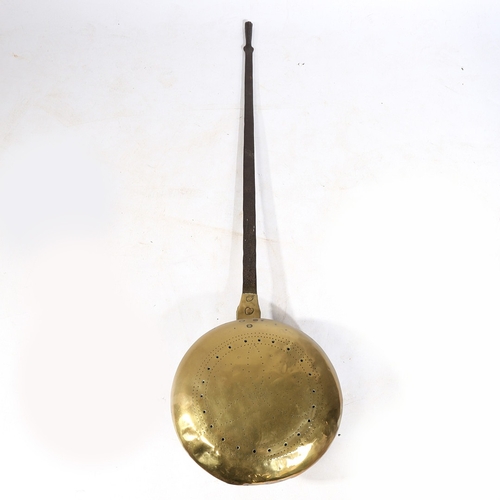 123 - A 17TH CENTURY BRASS AND IRON WARMING PAN. Having a domed pieced and geometric punched-decorated cov... 