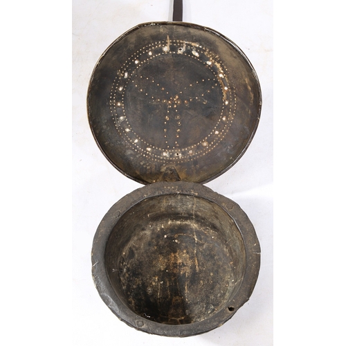 123 - A 17TH CENTURY BRASS AND IRON WARMING PAN. Having a domed pieced and geometric punched-decorated cov... 