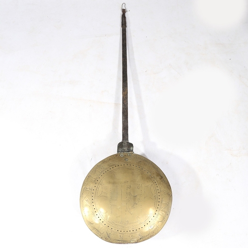 124 - A CHARLES II IRON AND BRASS WARMING PAN, DATED 1665. The circular lid decorated with the inscription... 