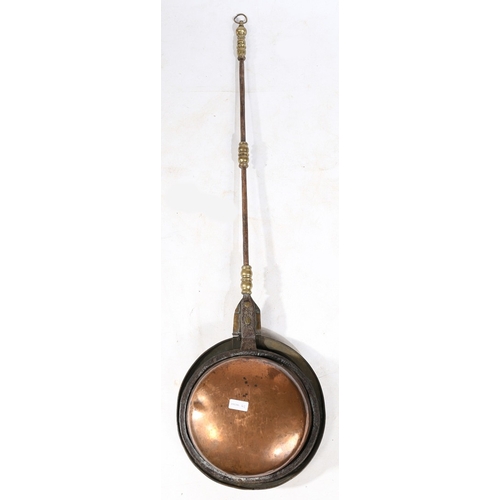 125 - A BRASS, IRON AND COPPER WARMING PAN, DUTCH, CIRCA 1700. The domed circular cover pierced and punch-... 