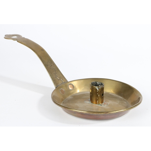 135 - A MID-18TH CENTURY BRASS CHAMBERSTICK, CIRCA 1750. The pan with rolled rim, the rolled candle socket... 