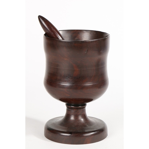 140 - A SMALL 18TH CENTURY LIGNUM VITAE STANDING MORTAR AND PESTLE, (2). Having a tulip-shaped bowl, short... 