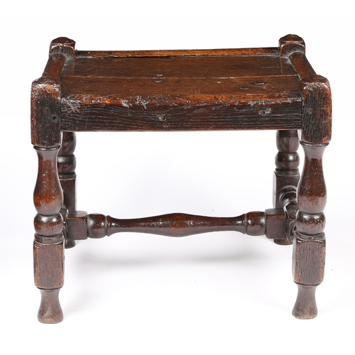 141 - AN UNCOMMON WILLIAM & MARY JOINED OAK STOOL, CIRCA 1690. Having a twin-boarded panelled seat, and di... 