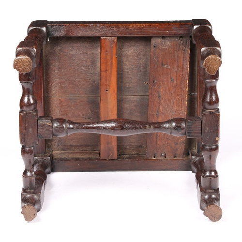 141 - AN UNCOMMON WILLIAM & MARY JOINED OAK STOOL, CIRCA 1690. Having a twin-boarded panelled seat, and di... 