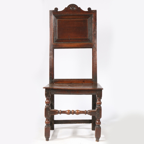 142 - AN UNUSUAL CHARLES II OAK BACKSTOOL, NORTH COUNTRY, CIRCA 1680. The tall and slender back with field... 