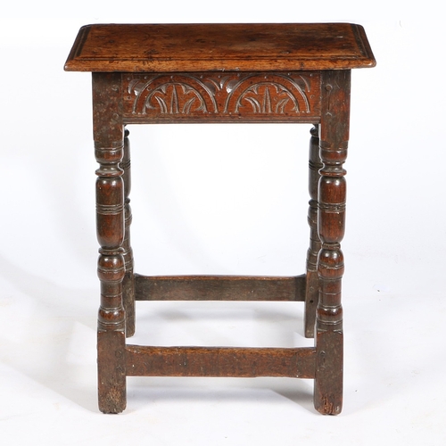 15 - A CHARLES I OAK JOINT STOOL, CIRCA 1640. Having a double-reeded top, and leafy-lunette carved rails,... 