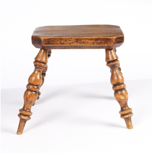 165 - A SMALL EARLY 19TH CENTURY ELM STOOL, ENGLISH/WELSH, CIRCA 1820-40. The rectangular cut-corner top o... 