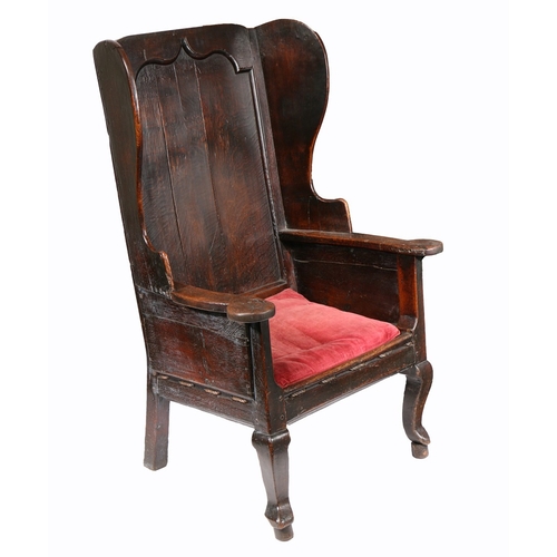 174 - AN IMPRESSIVE GEORGE I OAK WING-BACK ARMCHAIR, CIRCA 1720. Of majestic wide proportions, having a po... 