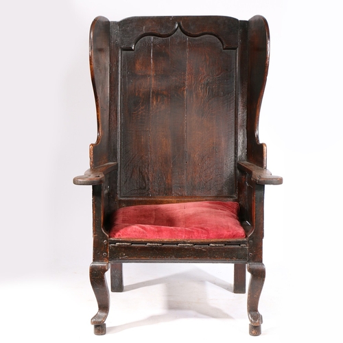 174 - AN IMPRESSIVE GEORGE I OAK WING-BACK ARMCHAIR, CIRCA 1720. Of majestic wide proportions, having a po... 