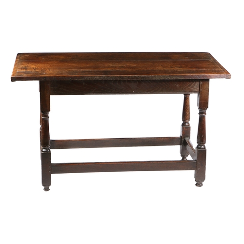 175 - A CHARLES I OAK LONG TABLE, CIRCA 1640. Having a boarded cleated top, the front rail channel moulded... 