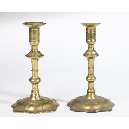 178 - TWO SIMILAR GEORGE II BRASS SOCKET CANDLESTICKS, ONE MAKER STAMPED, BIRMINGHAM, CIRCA 1755. Seamed, ... 