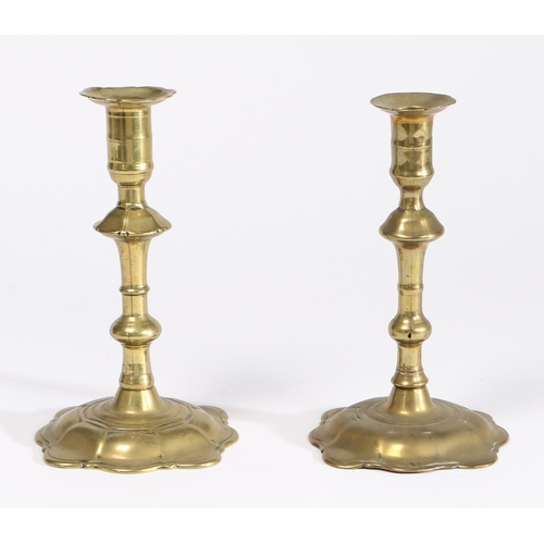 178 - TWO SIMILAR GEORGE II BRASS SOCKET CANDLESTICKS, ONE MAKER STAMPED, BIRMINGHAM, CIRCA 1755. Seamed, ... 