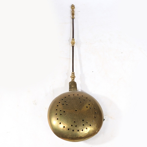 180 - A BRASS AND IRON WARMING PAN, DUTCH, CIRCA 1700. Having a domed, pierced and geometric punched -deco... 