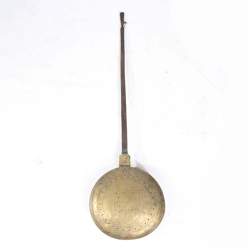 182 - A CHARLES I BRASS AND IRON WARMING PAN, CIRCA 1640. The circular domed brass cover decorated with th... 