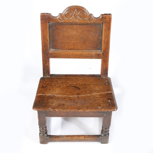 207 - A RARE CHARLES II OAK LOW BACKSTOOL, WITH DRAWER, CIRCA 1660. Having a rectangular plain back panel,... 