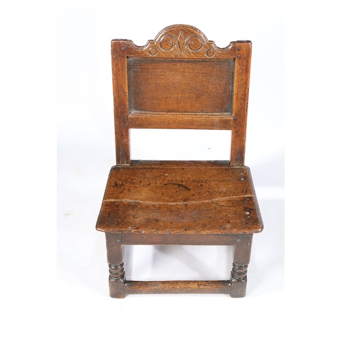 207 - A RARE CHARLES II OAK LOW BACKSTOOL, WITH DRAWER, CIRCA 1660. Having a rectangular plain back panel,... 