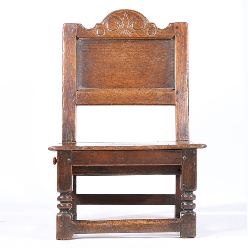 207 - A RARE CHARLES II OAK LOW BACKSTOOL, WITH DRAWER, CIRCA 1660. Having a rectangular plain back panel,... 