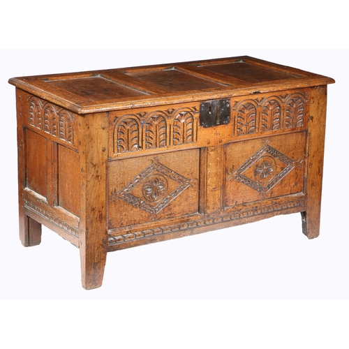 219 - A CHARLES I OAK COFFER, SOMERSET, CIRCA 1640. Having a triple panelled hinged lid, the front with a ... 