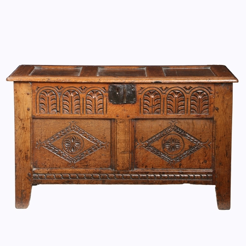 219 - A CHARLES I OAK COFFER, SOMERSET, CIRCA 1640. Having a triple panelled hinged lid, the front with a ... 