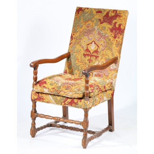 220 - A WALNUT AND UPHOLSTERED OPEN ARMCHAIR, FLEMISH, CIRCA 1700. The rectangular padded back, squab cush... 