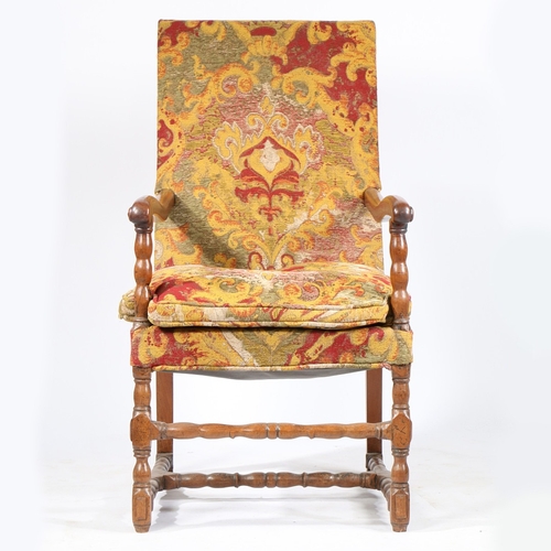 220 - A WALNUT AND UPHOLSTERED OPEN ARMCHAIR, FLEMISH, CIRCA 1700. The rectangular padded back, squab cush... 