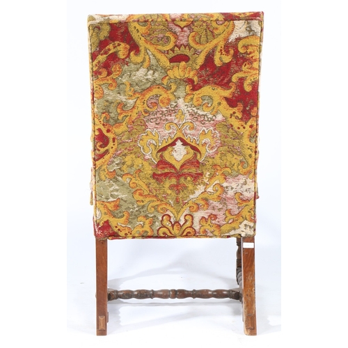 220 - A WALNUT AND UPHOLSTERED OPEN ARMCHAIR, FLEMISH, CIRCA 1700. The rectangular padded back, squab cush... 