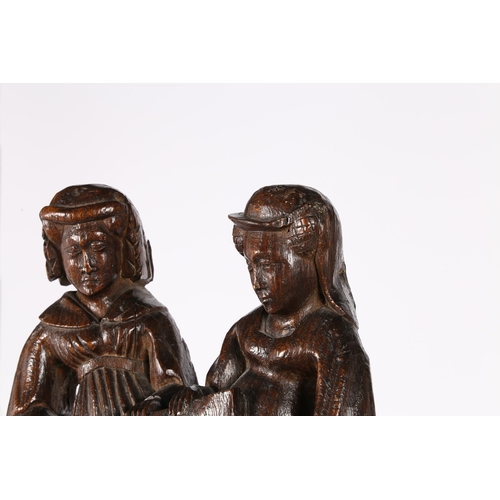 238 - A RARE AND GOOD EARLY 15TH CENTURY OAK FIGURAL PEW END, ENGLISH, CIRCA 1400. Designed with a pair of... 