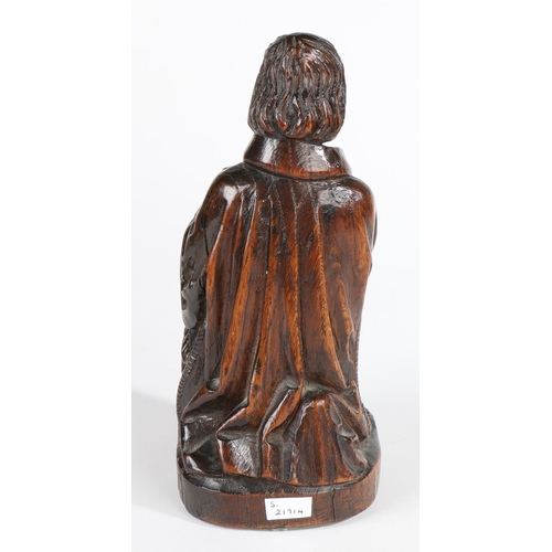 239 - A GOOD 16TH CENTURY CARVED OAK FIGURE OF A MALE MUSICIAN. Modelled seated, wearing flowing robes, a ... 