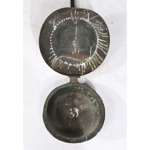 301 - A CHARLES I BRASS AND IRON WARMING PAN, CIRCA 1640. The circular brass cover decorated with the insc... 