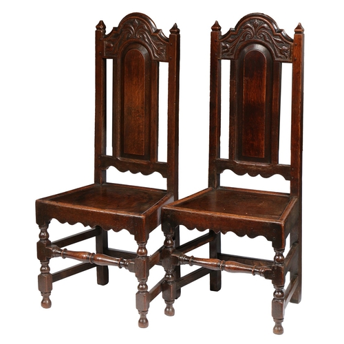 372 - A PAIR OF WILLIAM & MARY OAK HIGH-BACK CHAIRS, LANCASHIRE, CIRCA 1690. Each with a part open and arc... 