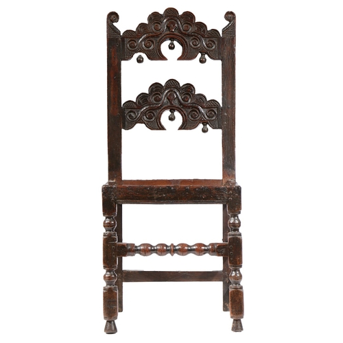 38 - A CHARLES II OAK BACKSTOOL, YORKSHIRE, CIRCA 1680. Having two arched, cusp-profiled, scroll and hatc... 