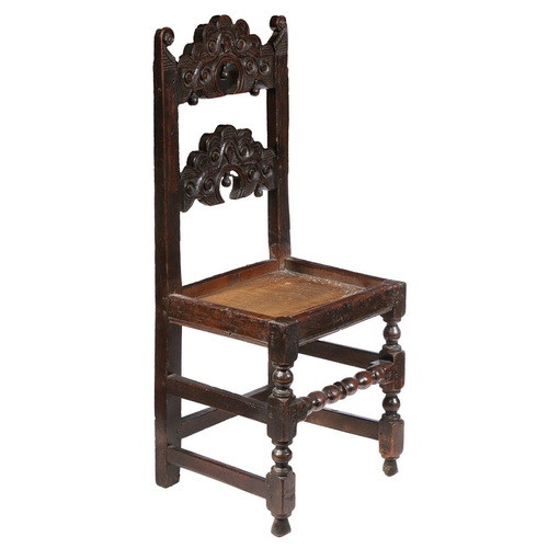 38 - A CHARLES II OAK BACKSTOOL, YORKSHIRE, CIRCA 1680. Having two arched, cusp-profiled, scroll and hatc... 