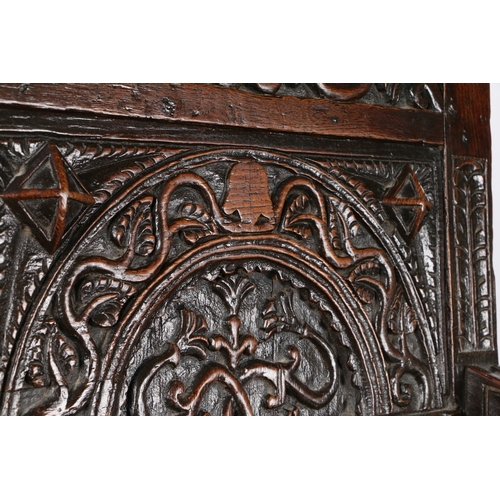 385 - A GOOD AND RARE ELIZABETH I OAK OPEN ARMCHAIR, CIRCA 1570. The back panel carved with a stylized flo... 