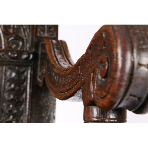 385 - A GOOD AND RARE ELIZABETH I OAK OPEN ARMCHAIR, CIRCA 1570. The back panel carved with a stylized flo... 