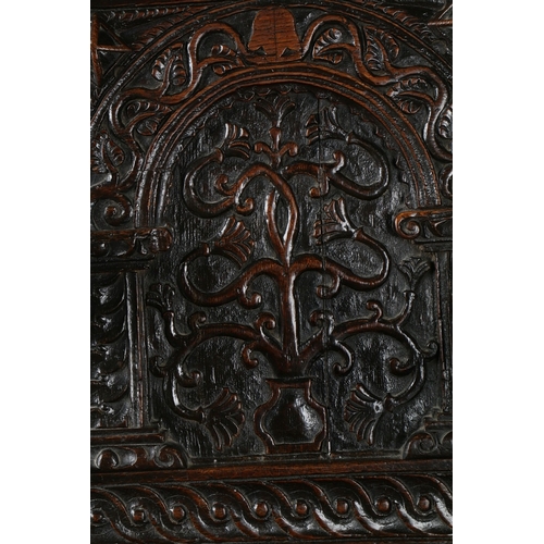 385 - A GOOD AND RARE ELIZABETH I OAK OPEN ARMCHAIR, CIRCA 1570. The back panel carved with a stylized flo... 