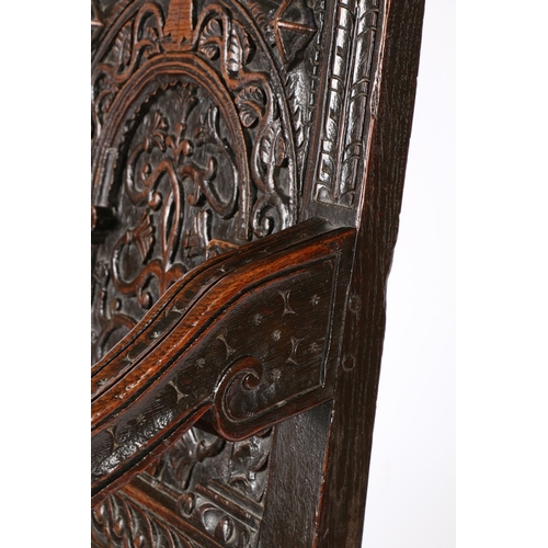 385 - A GOOD AND RARE ELIZABETH I OAK OPEN ARMCHAIR, CIRCA 1570. The back panel carved with a stylized flo... 