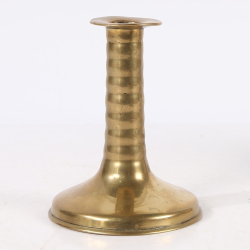 388 - A RARE CHARLES II BRASS TRUMPET-BASE SOCKET CANDLESTICK, CIRCA 1675. With corded stem, wide flat cir... 