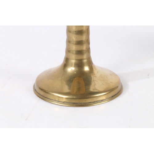 388 - A RARE CHARLES II BRASS TRUMPET-BASE SOCKET CANDLESTICK, CIRCA 1675. With corded stem, wide flat cir... 