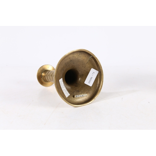 388 - A RARE CHARLES II BRASS TRUMPET-BASE SOCKET CANDLESTICK, CIRCA 1675. With corded stem, wide flat cir... 