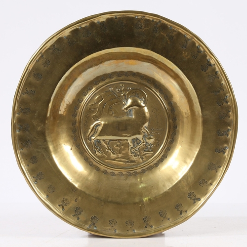 389 - A RARE SIZE 16TH CENTURY BRASS ALMS DISH, NUREMBERG, CIRCA 1500-50. Decorated with an Agnus Dei to c... 