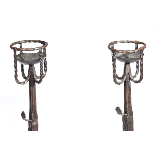 42 - A GOOD PAIR OF 17TH CENTURY STYLE IRON CRESSET FIREDOGS. Each with a twist-work cresset, triple spit... 