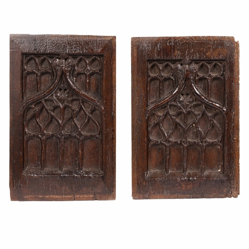 425 - A PAIR OF 15TH CENTURY OAK TRACERY CARVED PANELS, CIRCA 1450-80. Carved with tracery lights, couchet... 