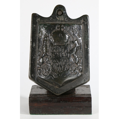 428 - A RARE CHARLES I BRONZE WOOL WEIGHT, CIRCA 1630. Of typical shield-shape, pierced for suspension and... 