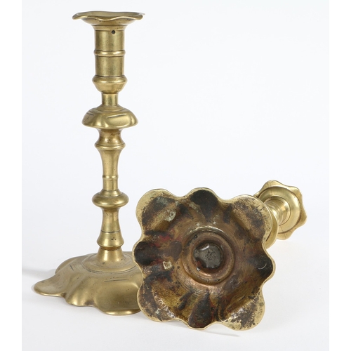 53 - A PAIR OF GEORGE II BRASS SOCKET CANDLESTICKS, CIRCA 1755. Each with an elongated and fillet centred... 