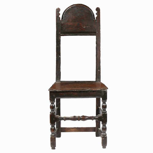 59 - A CHARLES II SLENDER OAK BACKSTOOL, YORKSHIRE, CIRCA 1670. The open back with deep arched cresting r... 